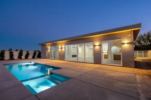 a view of a house with a swimming pool and a porch