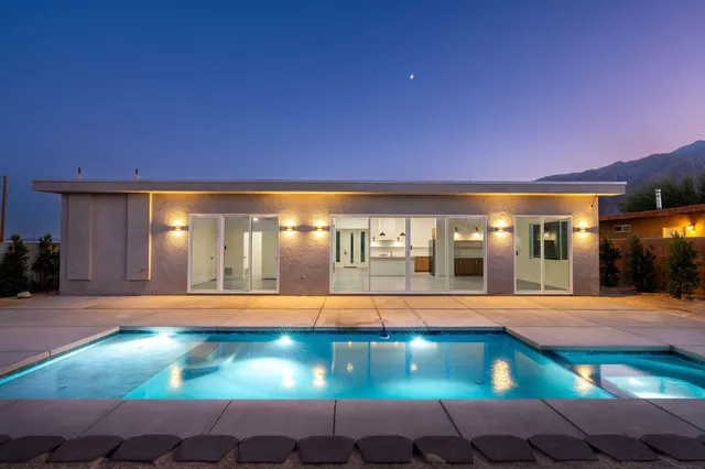 a view of room with two windows and a ceiling fan