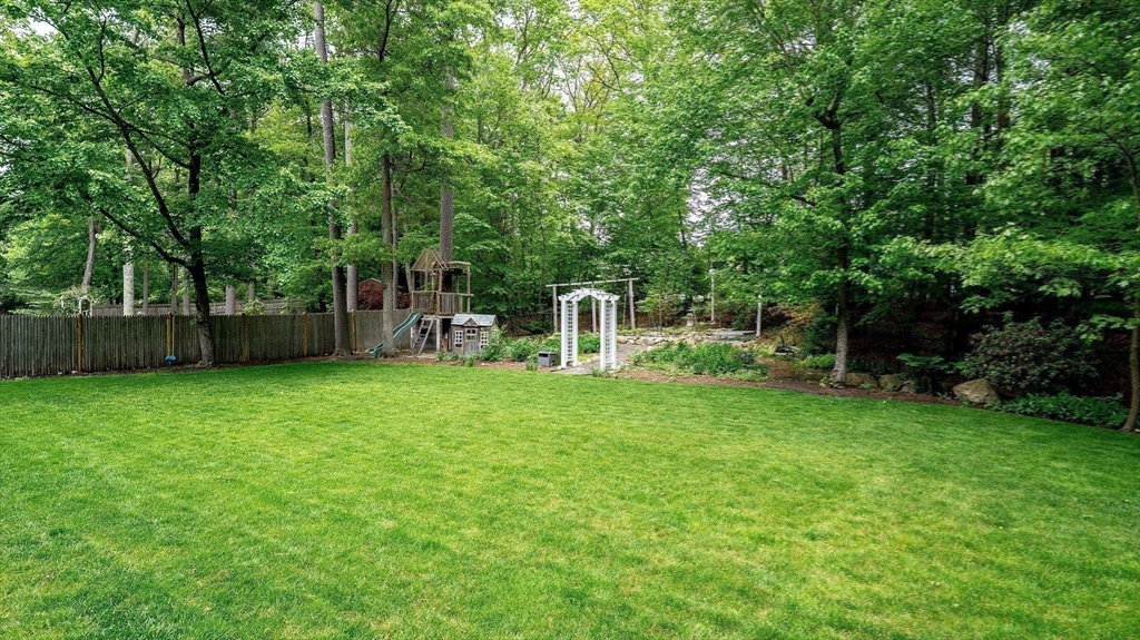 142 Baker Street Walpole, MA 02081 - Photo 42 of 42 a view of a backyard with table and chairs and a large tree