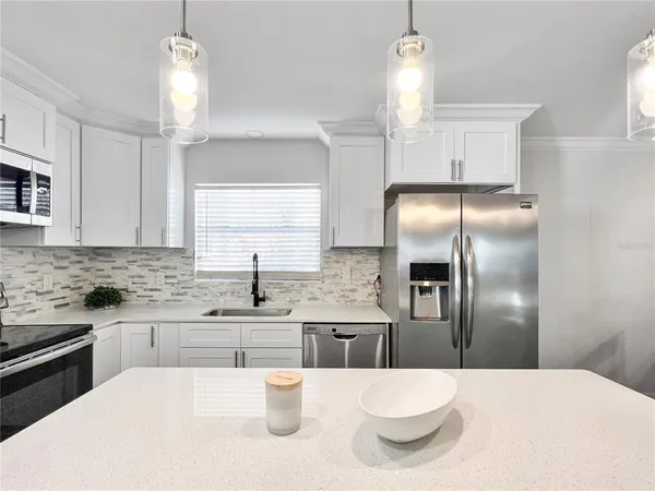 a kitchen with a sink and refrigerator
