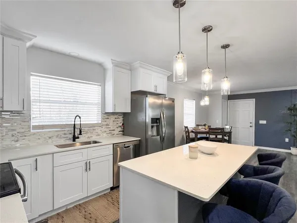 a kitchen with a sink a counter space cabinets and stainless steel appliances