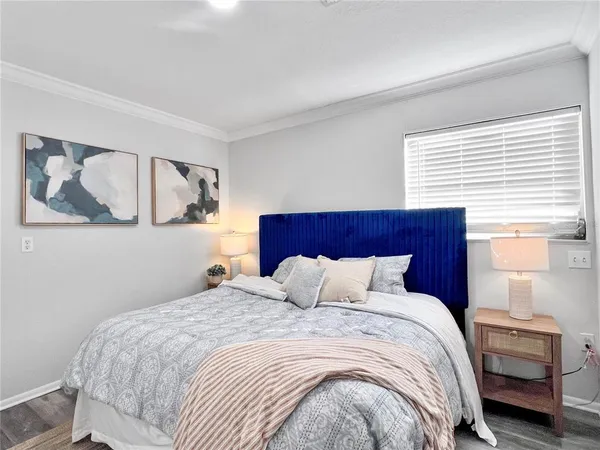 a bedroom with a large bed and a window