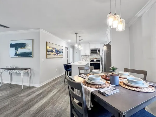 a view of a dining room with furniture and wooden floor