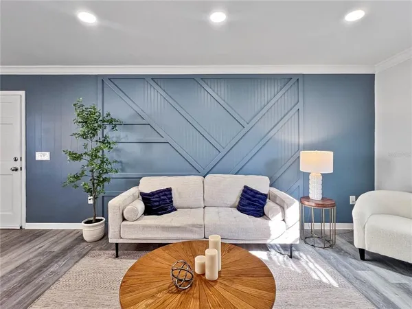 a living room with furniture and a potted plant