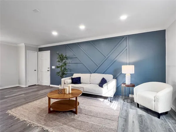 a living room with furniture and a potted plant