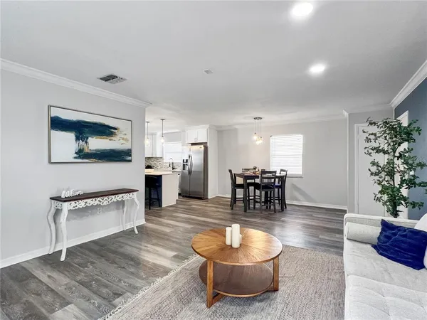 a living room with furniture and a potted plant