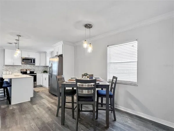 a view of a dining room with furniture and wooden floor