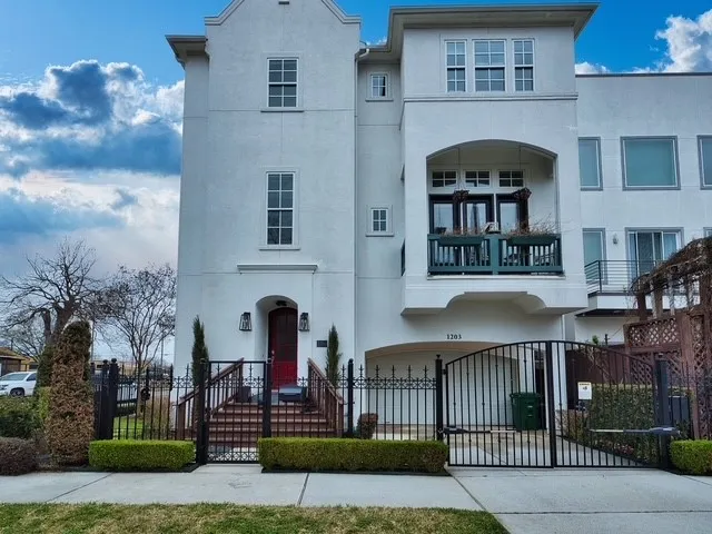 a front view of a house with glass windows and entertaining space