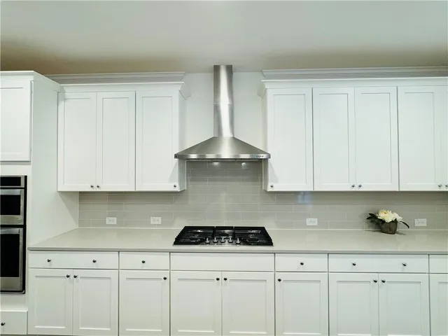 a kitchen with cabinets and stainless steel appliances