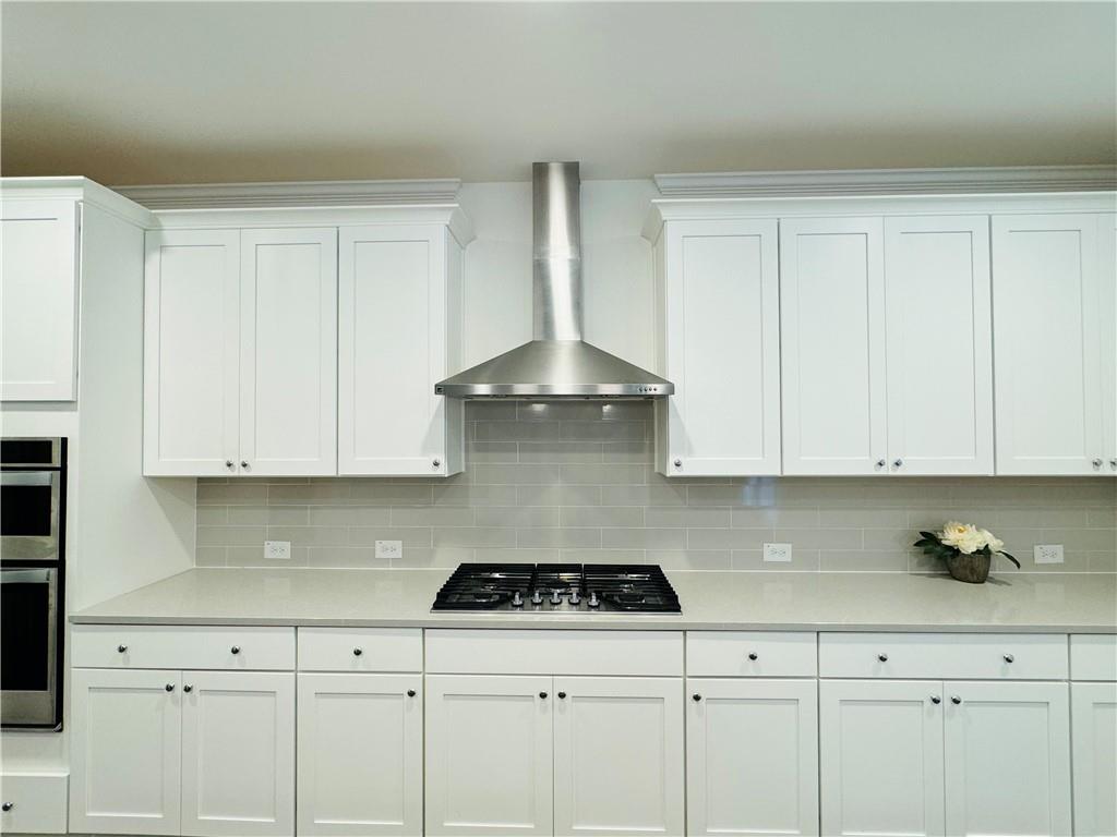 210 Hamlet Drive Duluth, GA 30097 - Photo 11 of 39 a kitchen with white cabinets and appliances
