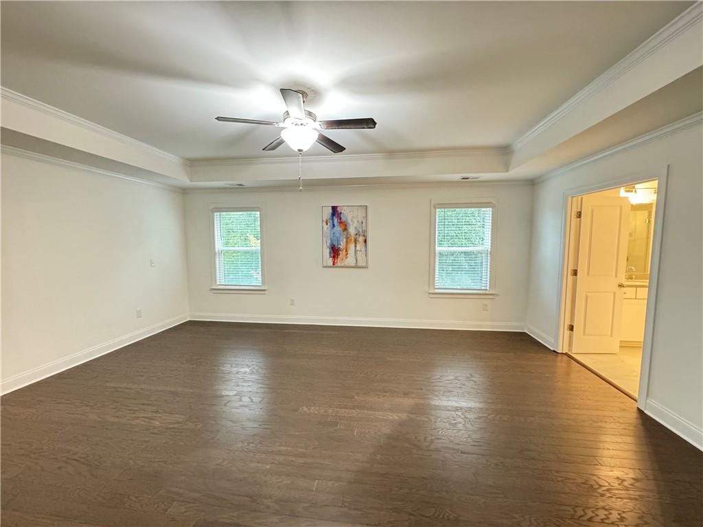 210 Hamlet Drive Duluth, GA 30097 - Photo 19 of 39 an empty room with wooden floor fan and windows