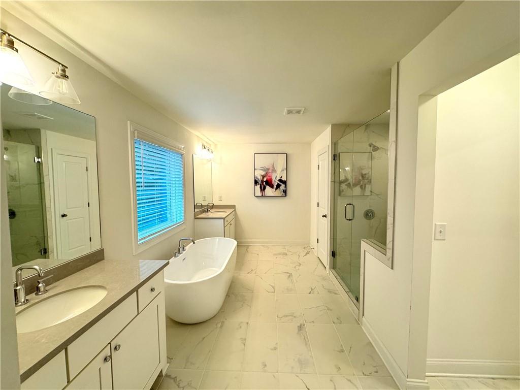 210 Hamlet Drive Duluth, GA 30097 - Photo 20 of 39 a bathroom with a double vanity sink toilet and shower