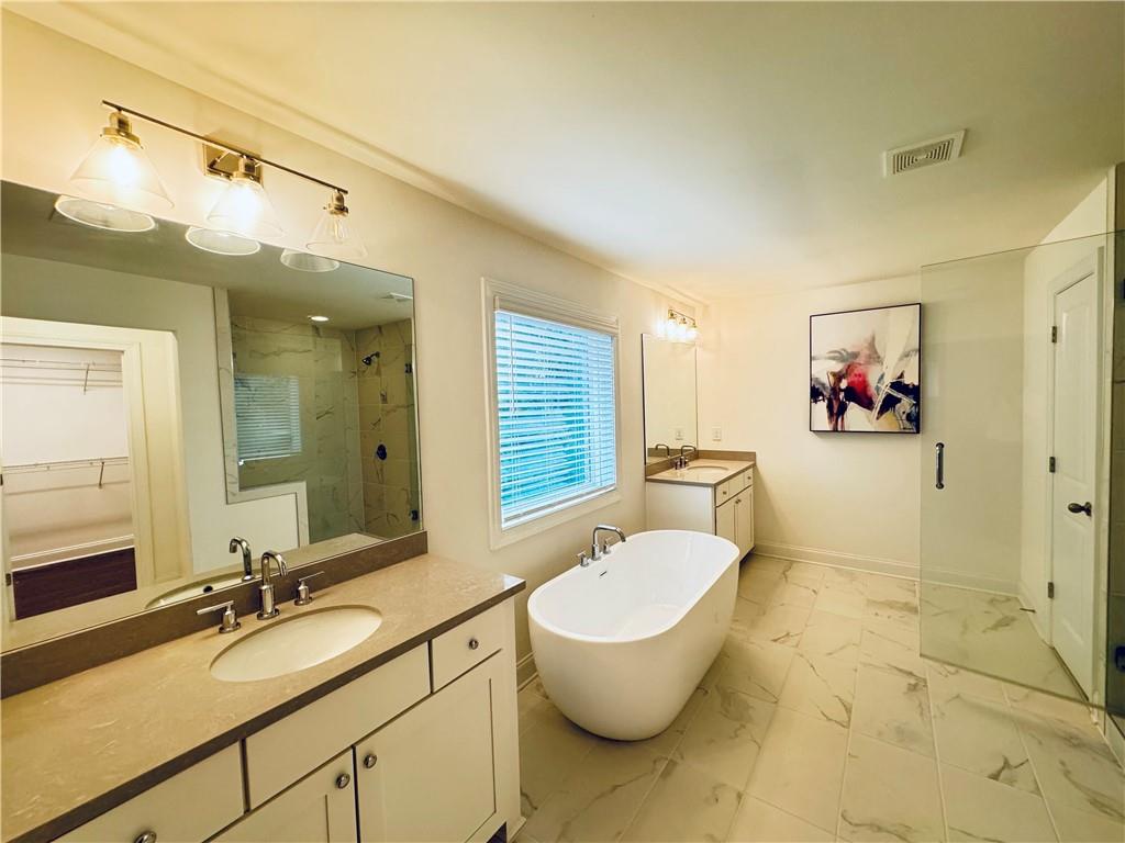 210 Hamlet Drive Duluth, GA 30097 - Photo 21 of 39 a spacious bathroom with a granite countertop sink and a mirror