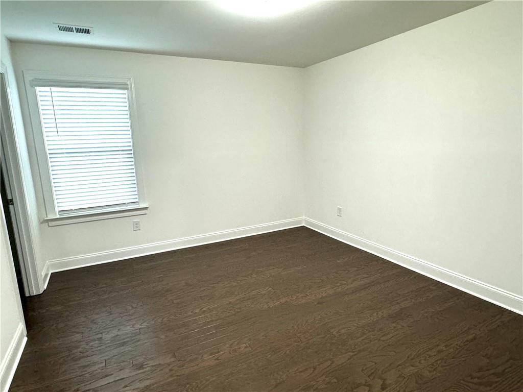210 Hamlet Drive Duluth, GA 30097 - Photo 25 of 39 an empty room with wooden floor and windows