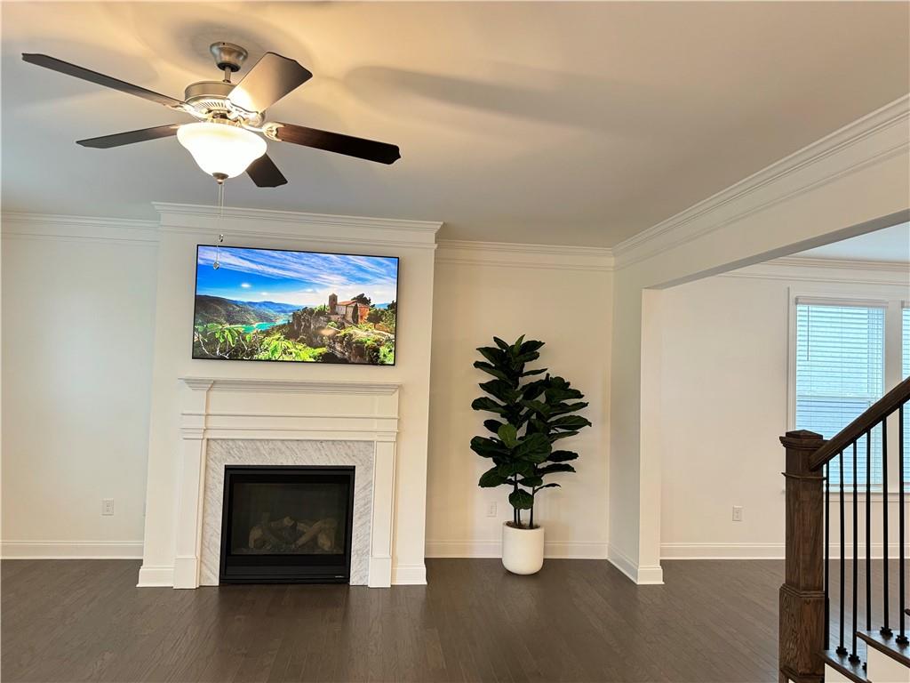 210 Hamlet Drive Duluth, GA 30097 - Photo 6 of 39 a living room with furniture a fireplace and a flat screen tv