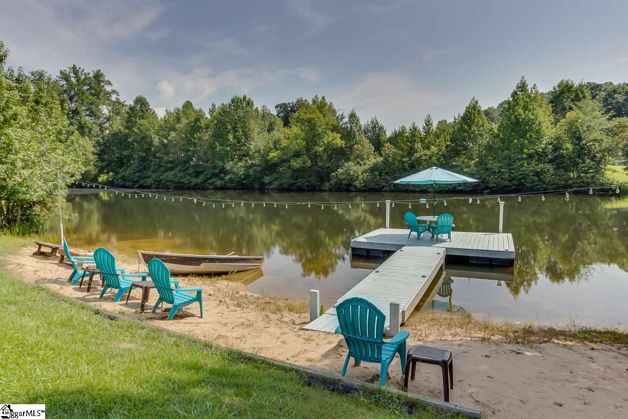 111 Trammell Road Travelers Rest, SC 29690 - Photo 34 of 36 This is a view of your own private beach. If you want to swim in the pond instead of the pool you have that option. The dogs love it and the pond is stocked and balanced. The dock is constructed to weather lake climates.