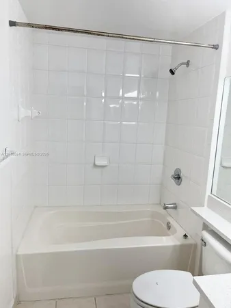 a bathroom with a toilet and a bath tub