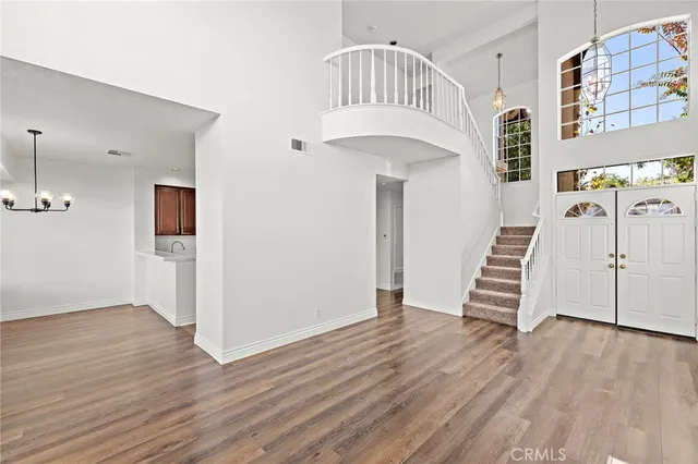a view of an entryway with wooden floor