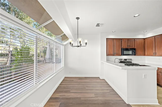 a view of a kitchen with a sink wooden floor and windows