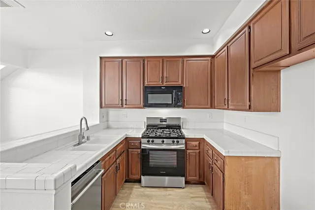 a kitchen with sink a stove and cabinets