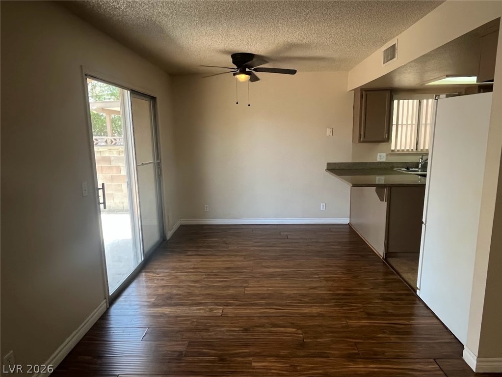 914 Scarlet Ridge Drive Las Vegas, NV 89128 - Photo 6 of 25 Hardwood floors and sliding glass doors create a naturally illuminated open space.