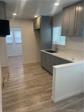 a kitchen with stainless steel appliances granite countertop a sink a stove and a refrigerator