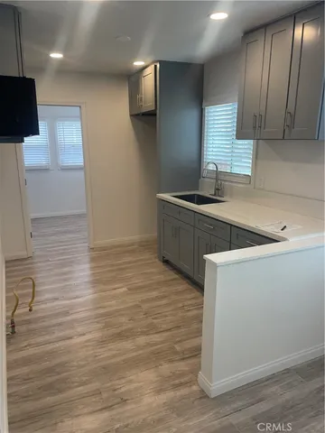 a kitchen with stainless steel appliances granite countertop a sink a stove and a refrigerator