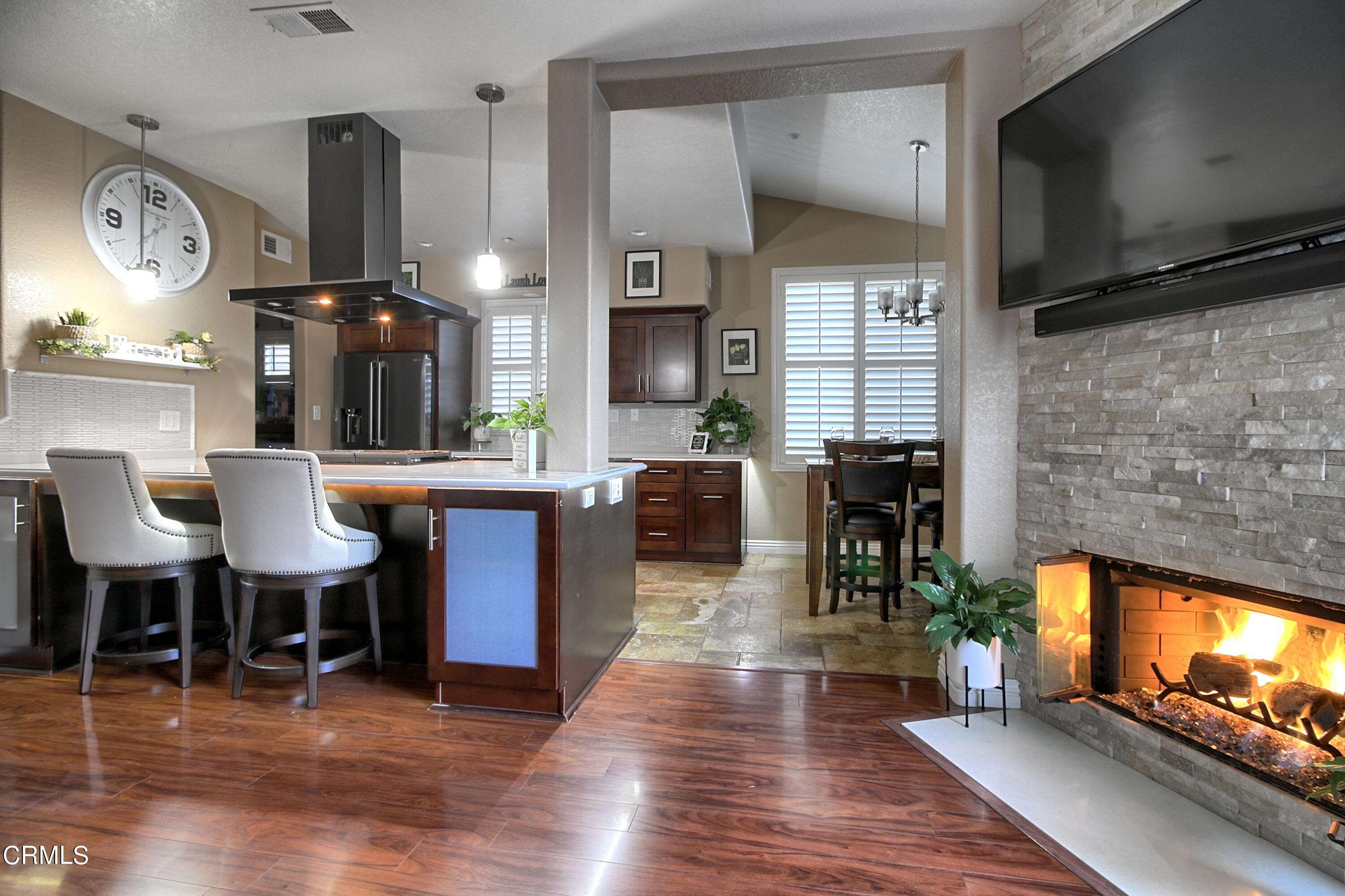 2062 Avila Place Oxnard, CA 93036 - Photo 10 of 52 a living room with furniture a fireplace and a flat screen tv