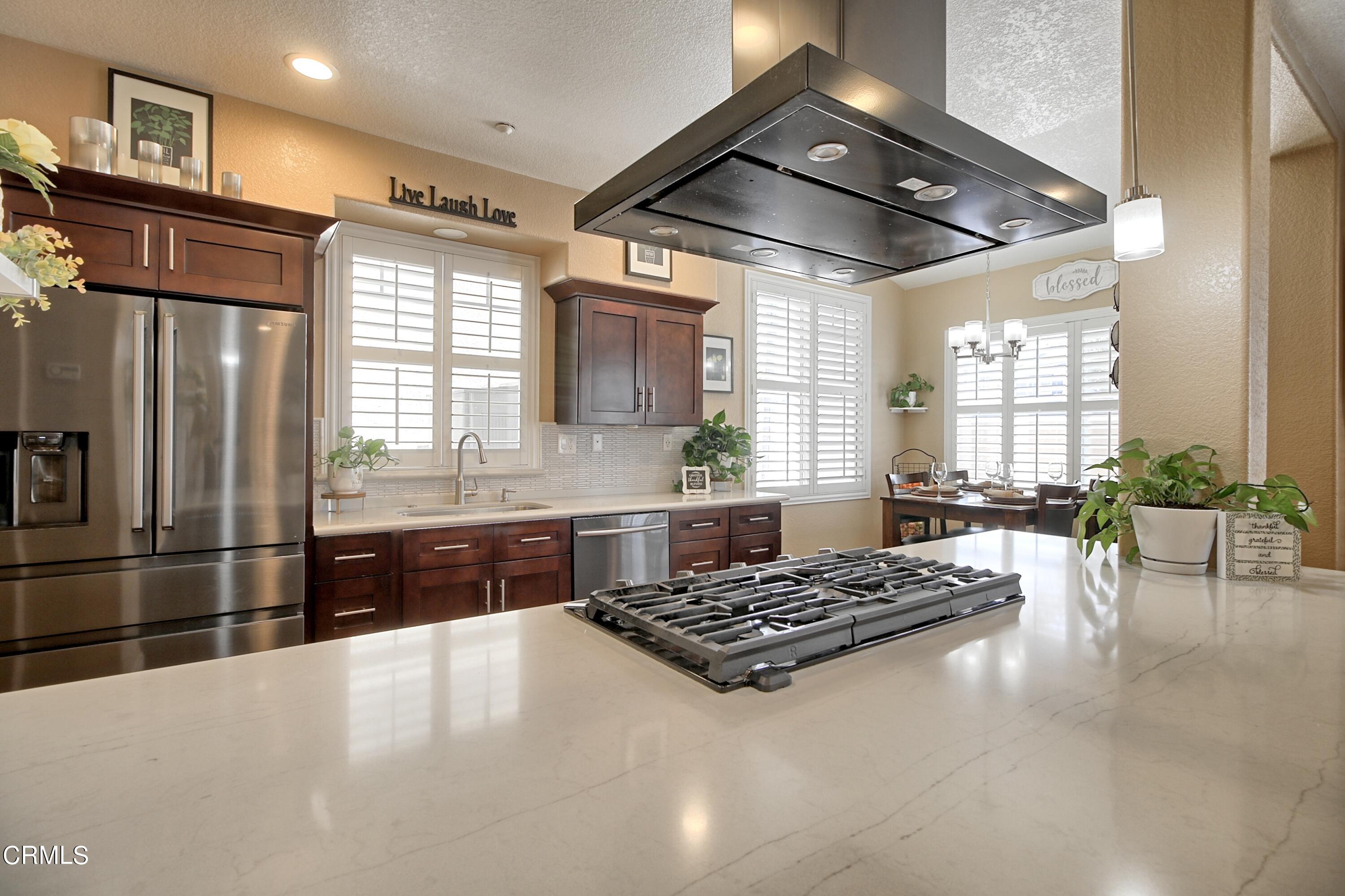 2062 Avila Place Oxnard, CA 93036 - Photo 17 of 52 a large kitchen with stainless steel appliances granite countertop a stove and a sink