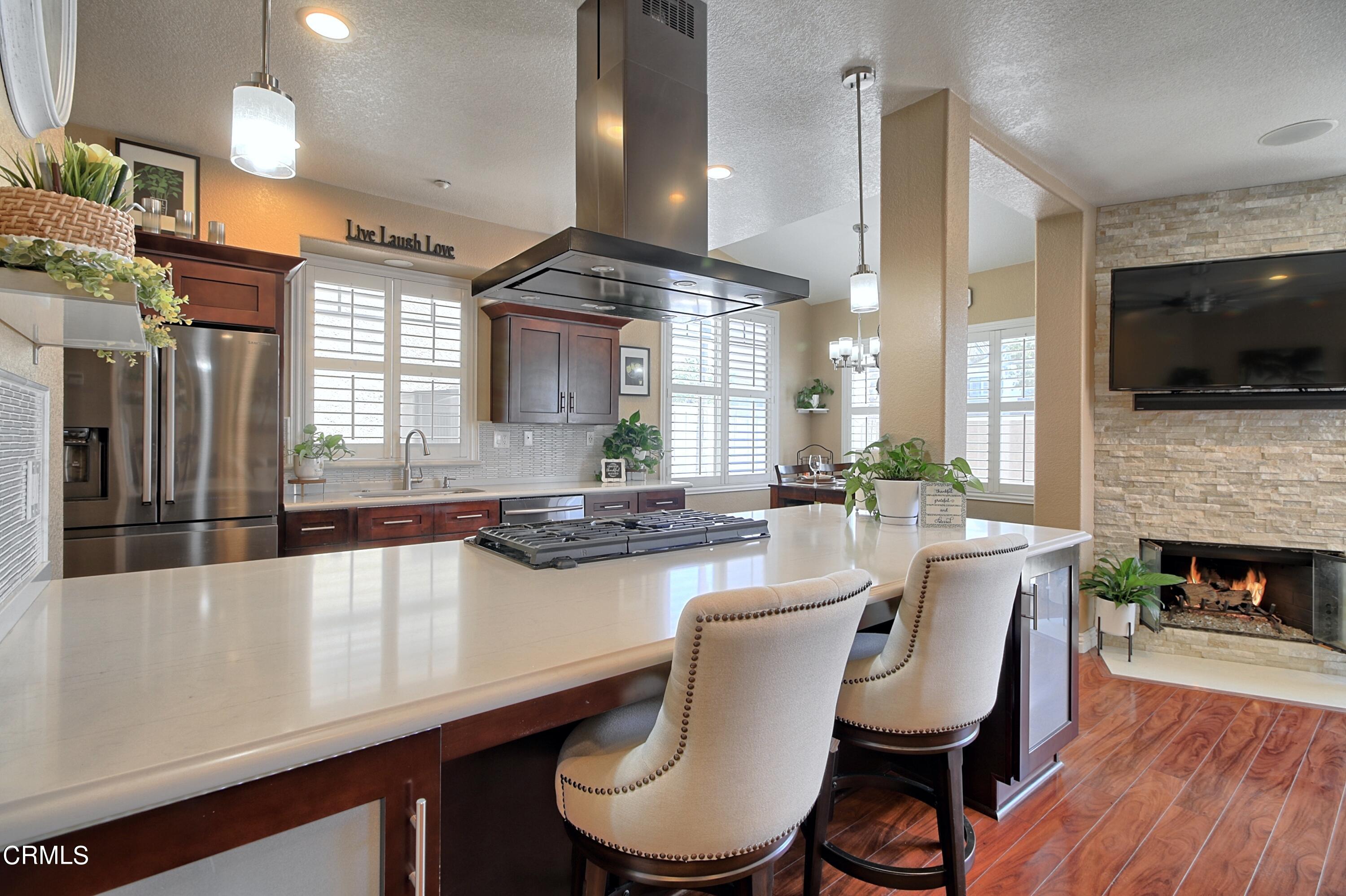 2062 Avila Place Oxnard, CA 93036 - Photo 2 of 52 a large kitchen with a table and chairs