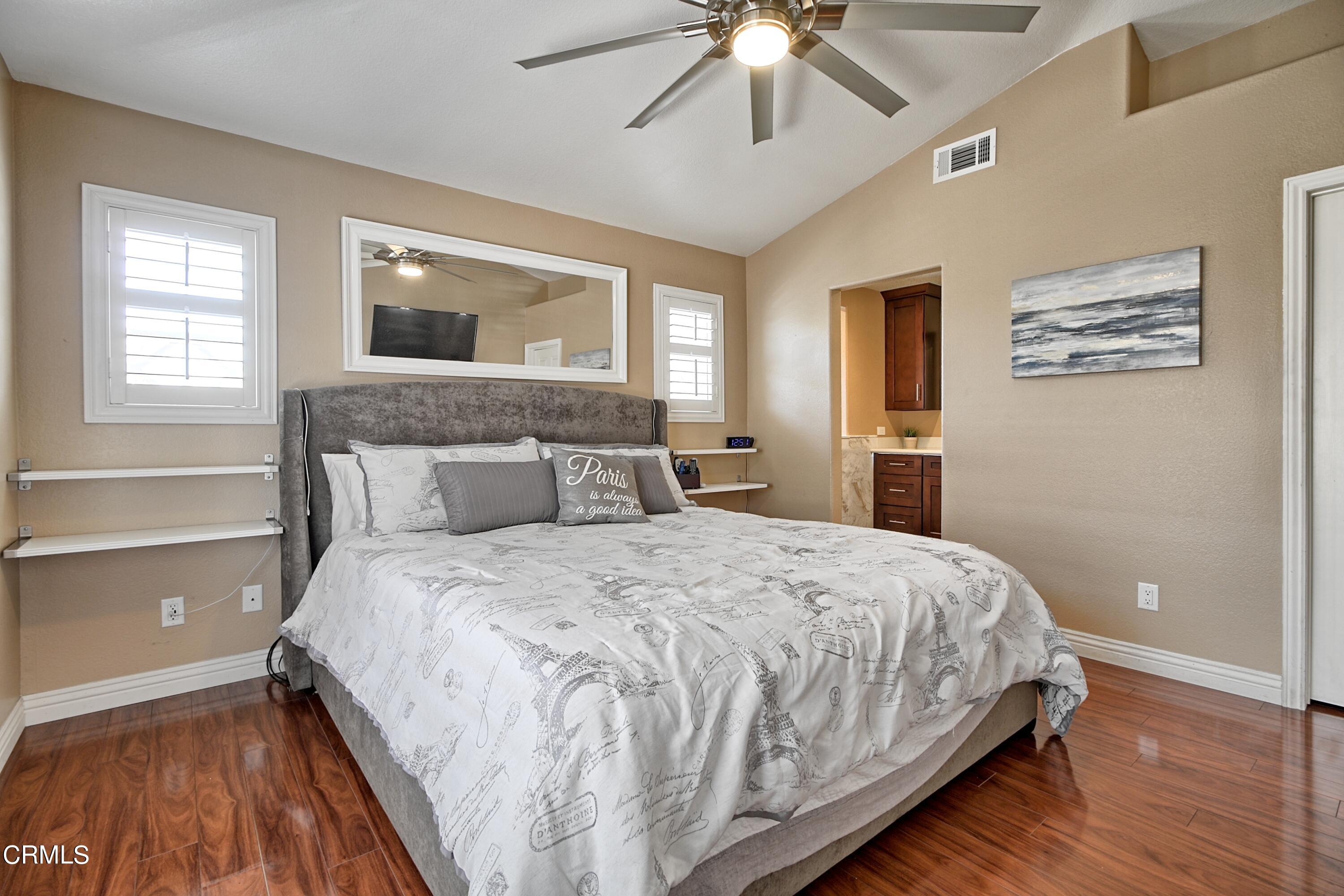 2062 Avila Place Oxnard, CA 93036 - Photo 18 of 52 a bedroom with a large bed and a chandelier