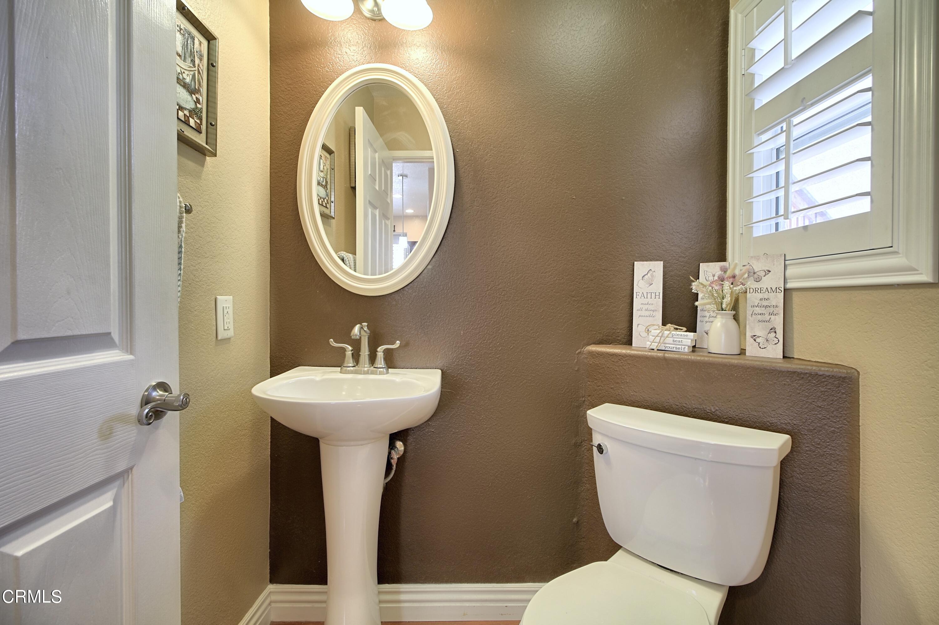 2062 Avila Place Oxnard, CA 93036 - Photo 25 of 52 a bathroom with a toilet a sink and a mirror