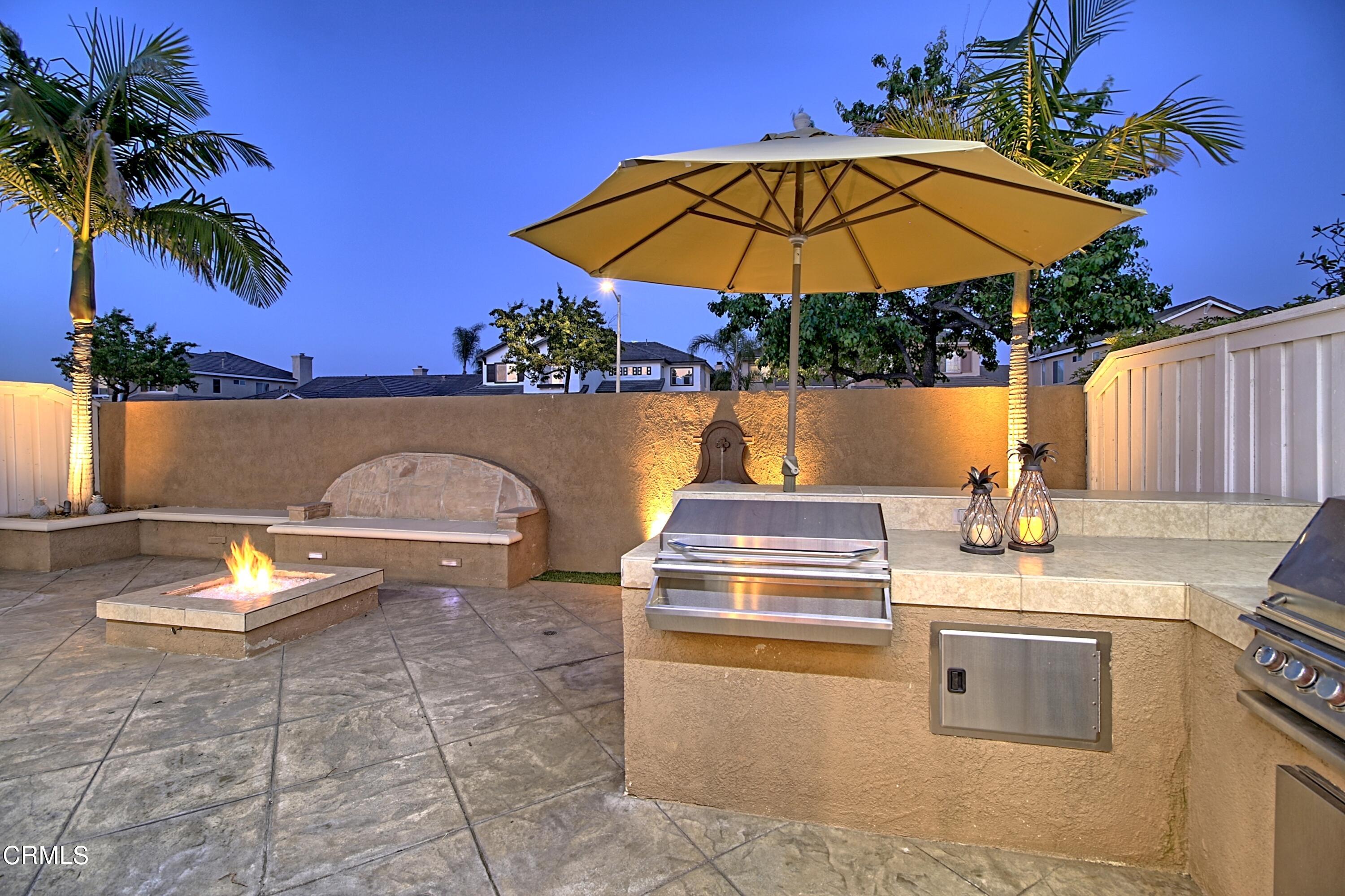 2062 Avila Place Oxnard, CA 93036 - Photo 36 of 52 a view of a patio with a table and chairs under an umbrella