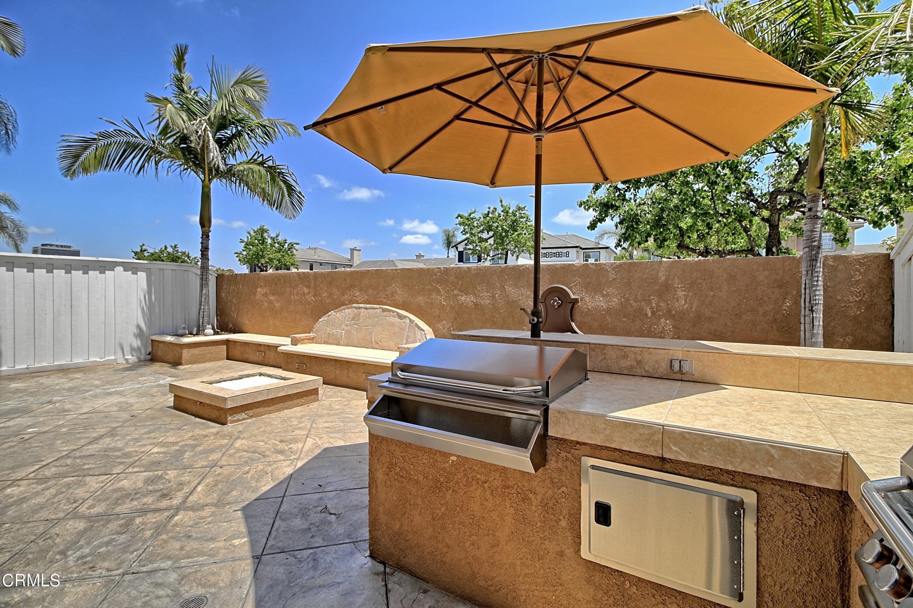 2062 Avila Place Oxnard, CA 93036 - Photo 37 of 52 a view of a backyard with couches under an umbrella