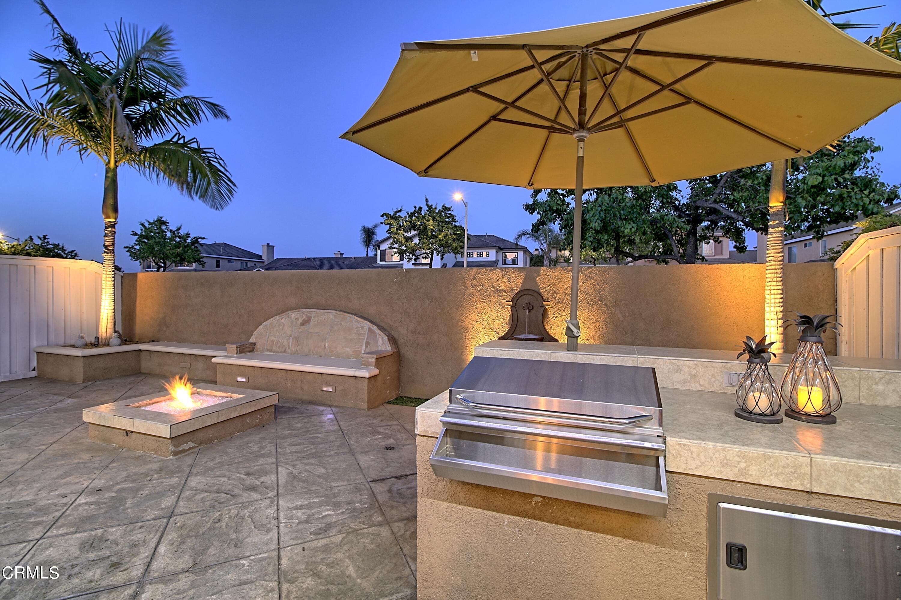 2062 Avila Place Oxnard, CA 93036 - Photo 39 of 52 a view of a backyard with chairs and a umbrella