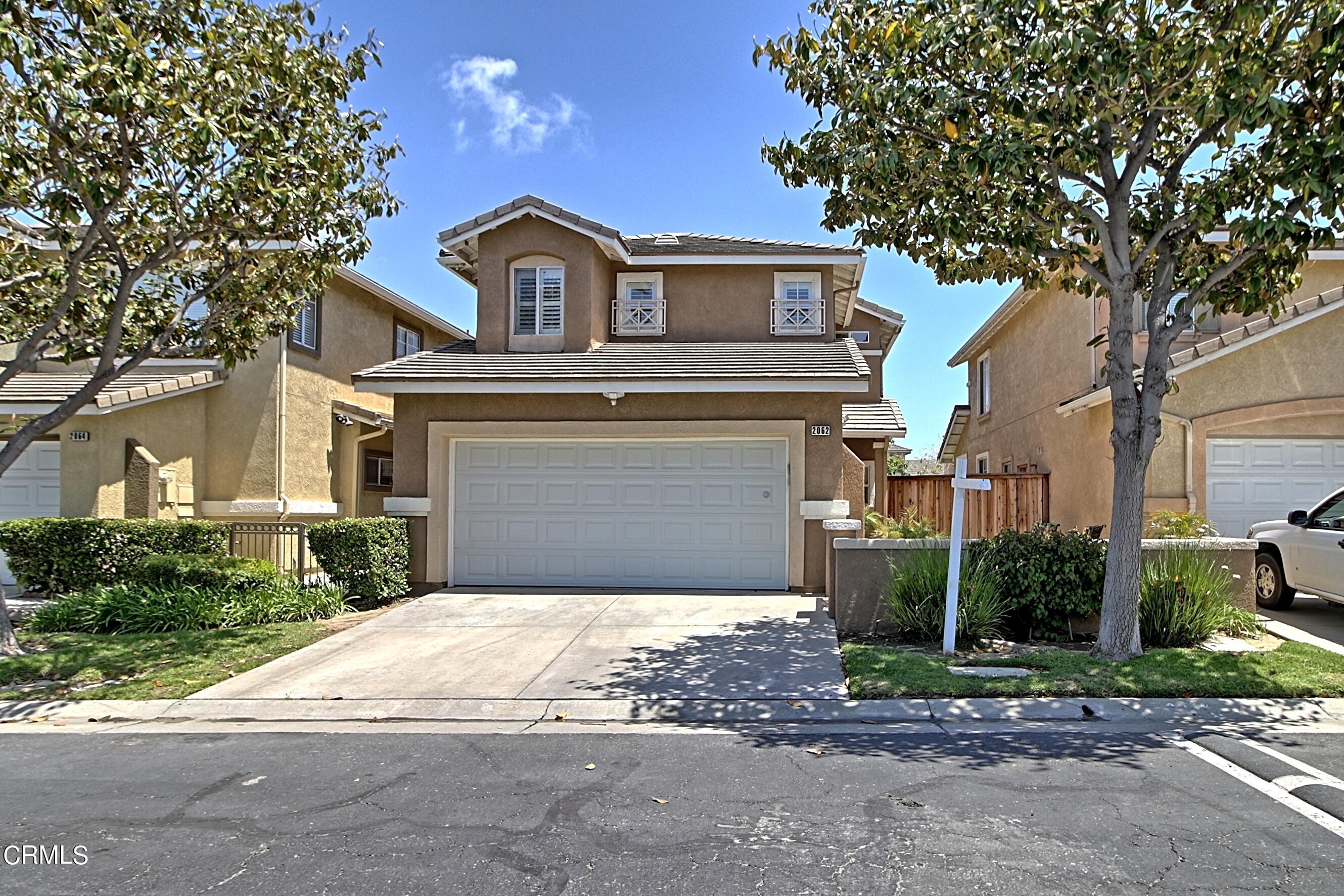 2062 Avila Place Oxnard, CA 93036 - Photo 44 of 52 a front view of a house with a yard and garage