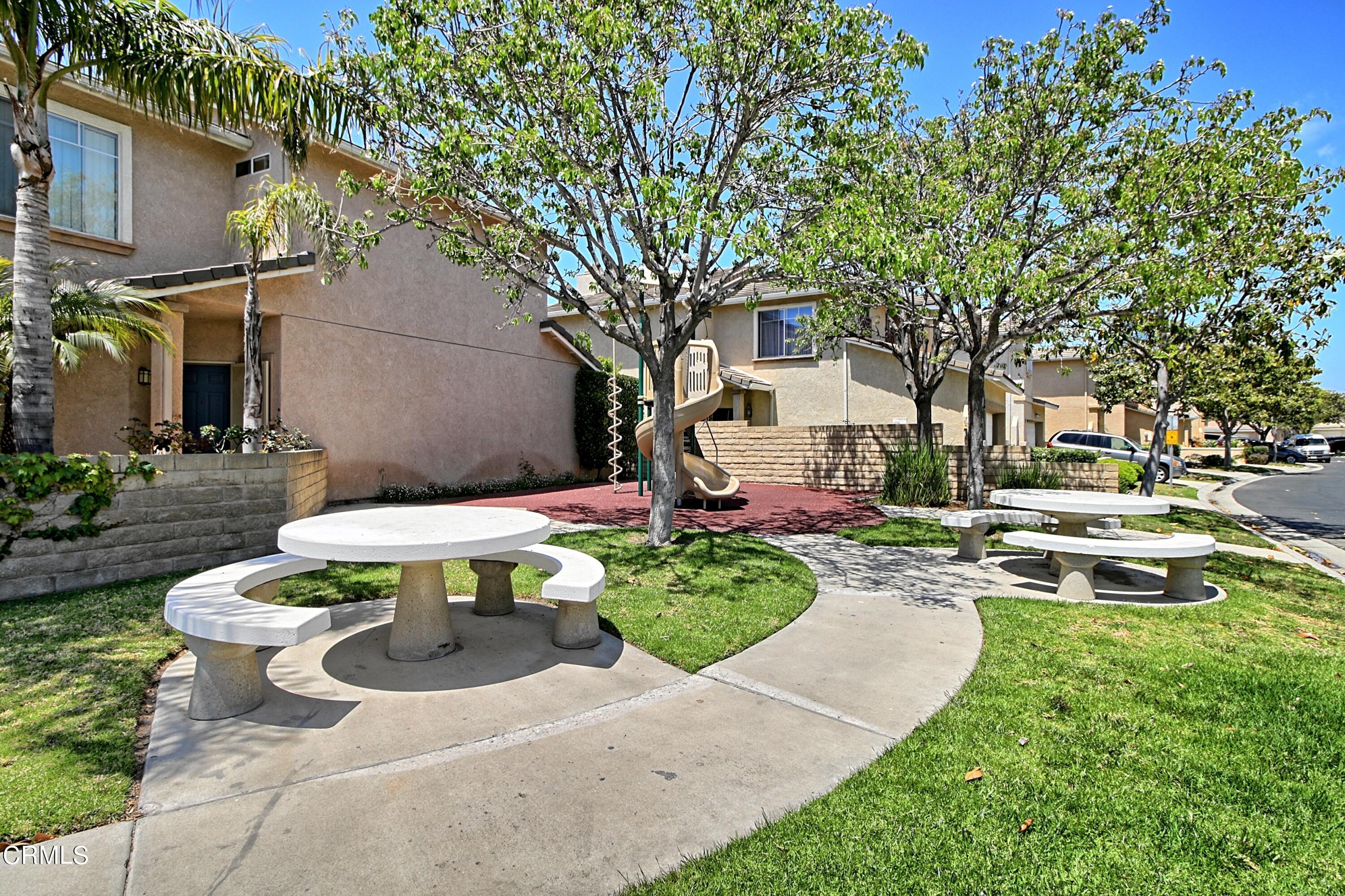 2062 Avila Place Oxnard, CA 93036 - Photo 48 of 52 a view of a backyard with table and chairs under an umbrella