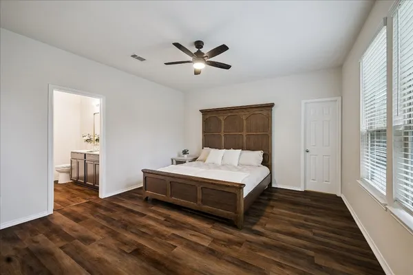 a spacious bedroom with a bed and a window