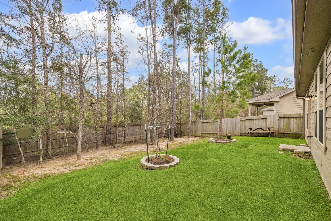 4275 Pine Still Road Conroe, TX 77304 - Photo 19 of 20 a view of a backyard with a garden