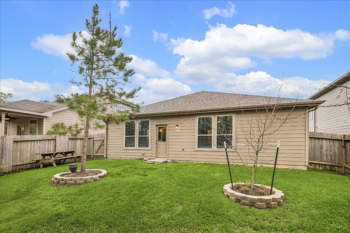 4275 Pine Still Road Conroe, TX 77304 - Photo 20 of 20 a swimming pool with outdoor seating and yard