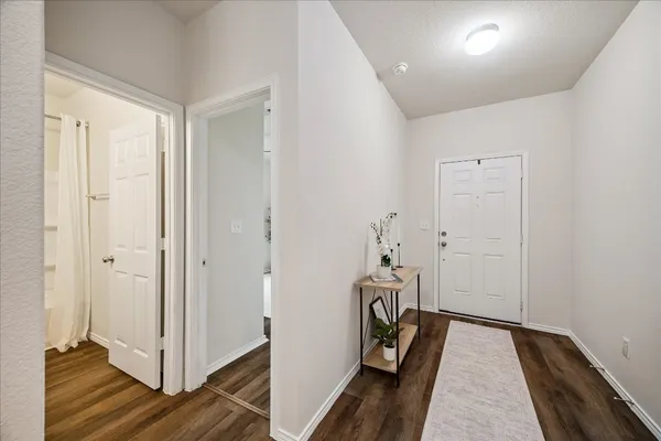 a view of a hallway with wooden floor