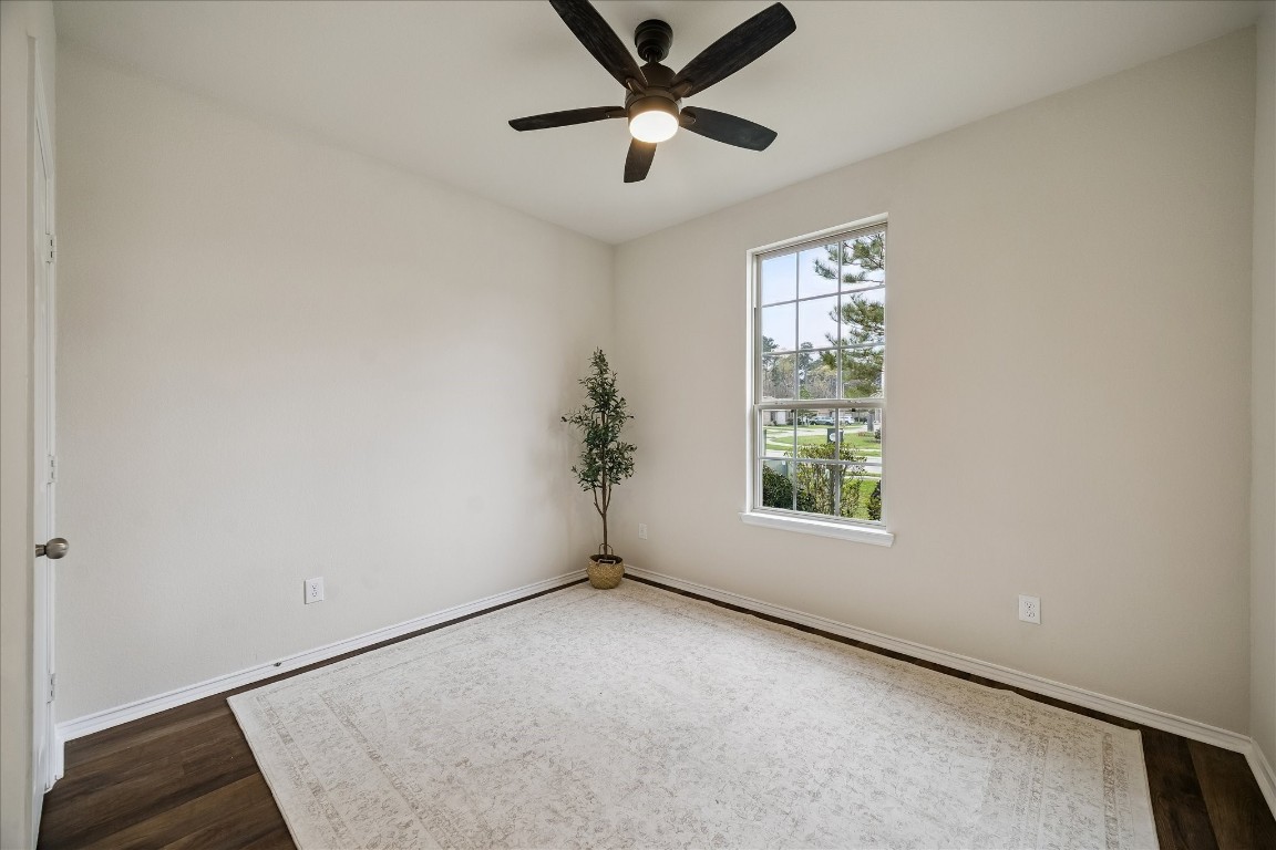 4275 Pine Still Road Conroe, TX 77304 - Photo 5 of 20 an empty room with a window and a fan