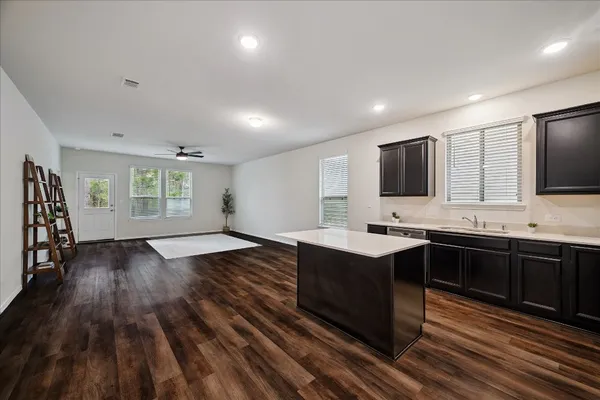 a kitchen with wooden floors and wooden cabinets