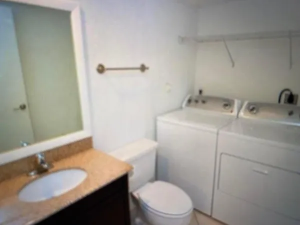 a bathroom with a sink toilet vanity and tub