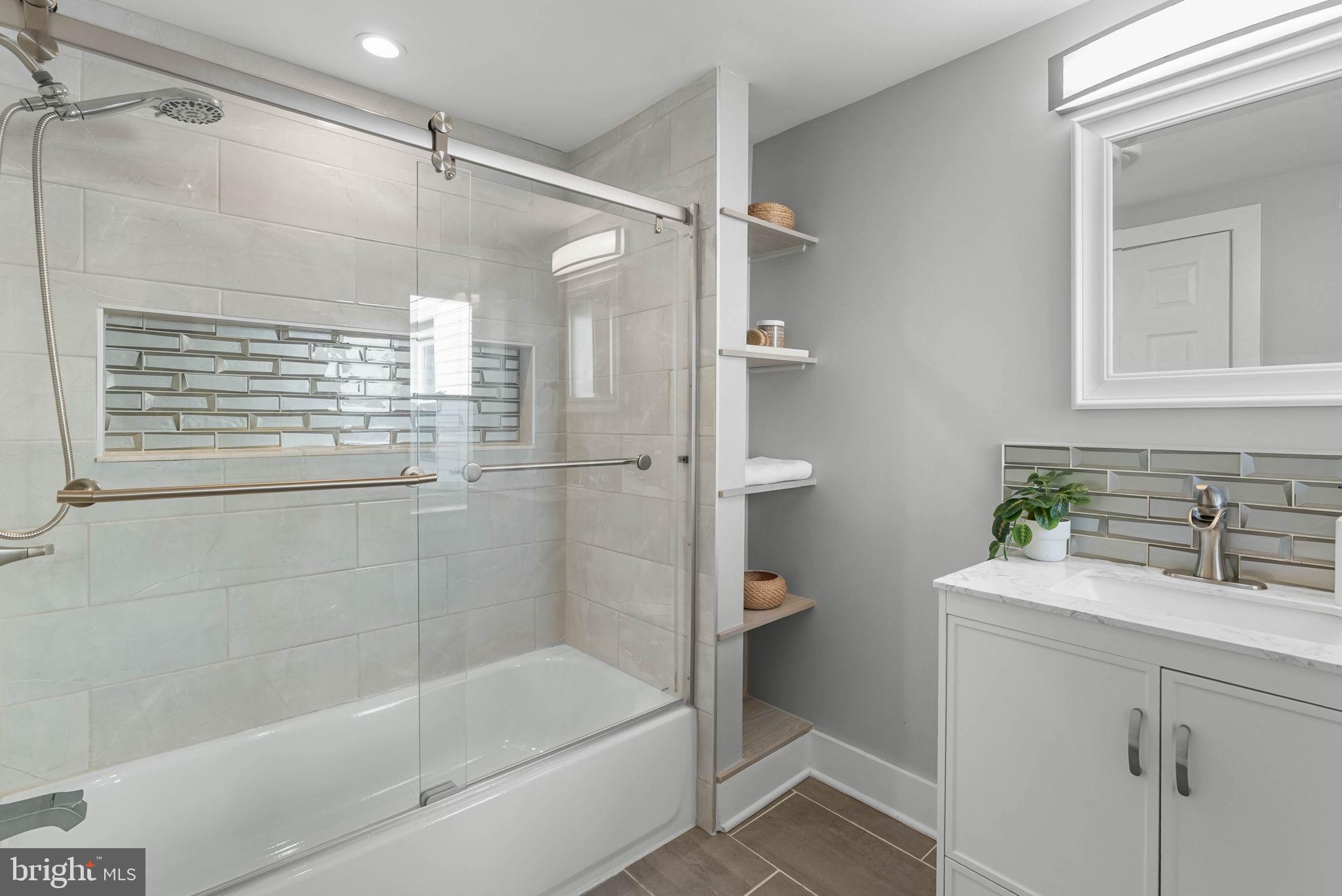 2639 Ellsworth Street Philadelphia, PA 19146 - Photo 12 of 20 a bathroom with a bathtub shower sink vanity and a toilet