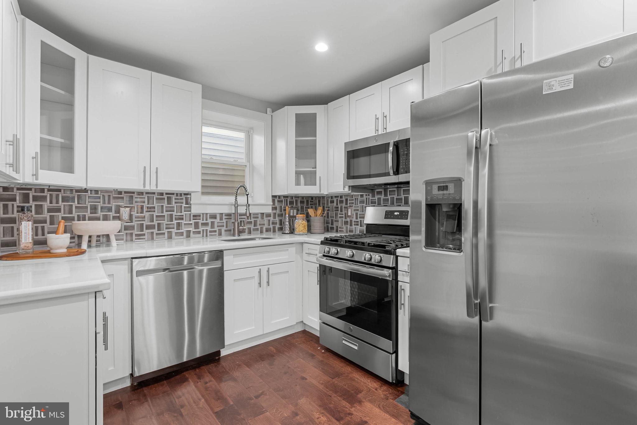 2639 Ellsworth Street Philadelphia, PA 19146 - Photo 4 of 20 a kitchen with stainless steel appliances a stove sink and microwave