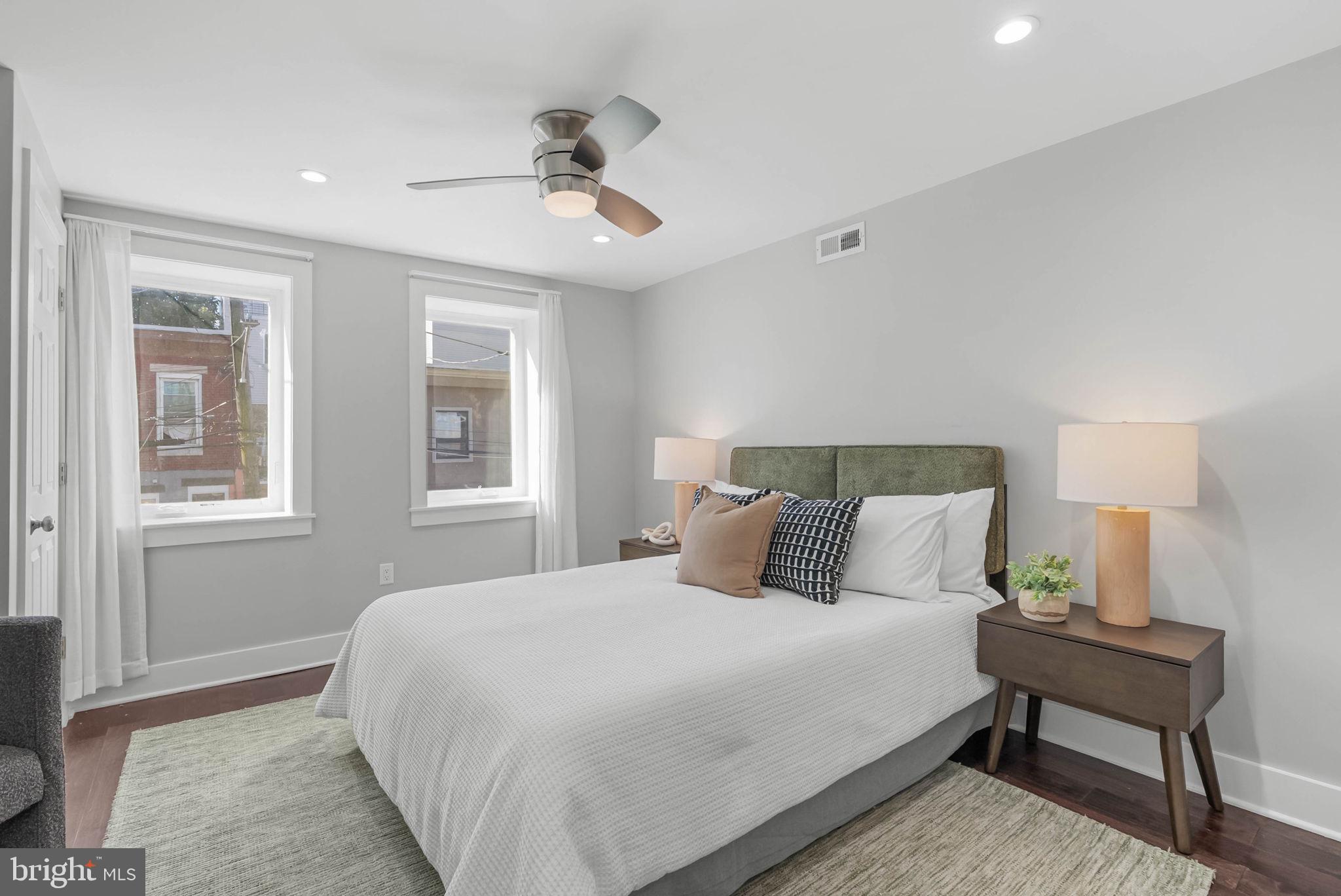 2639 Ellsworth Street Philadelphia, PA 19146 - Photo 9 of 20 a bedroom with a bed and a lamp on dresser