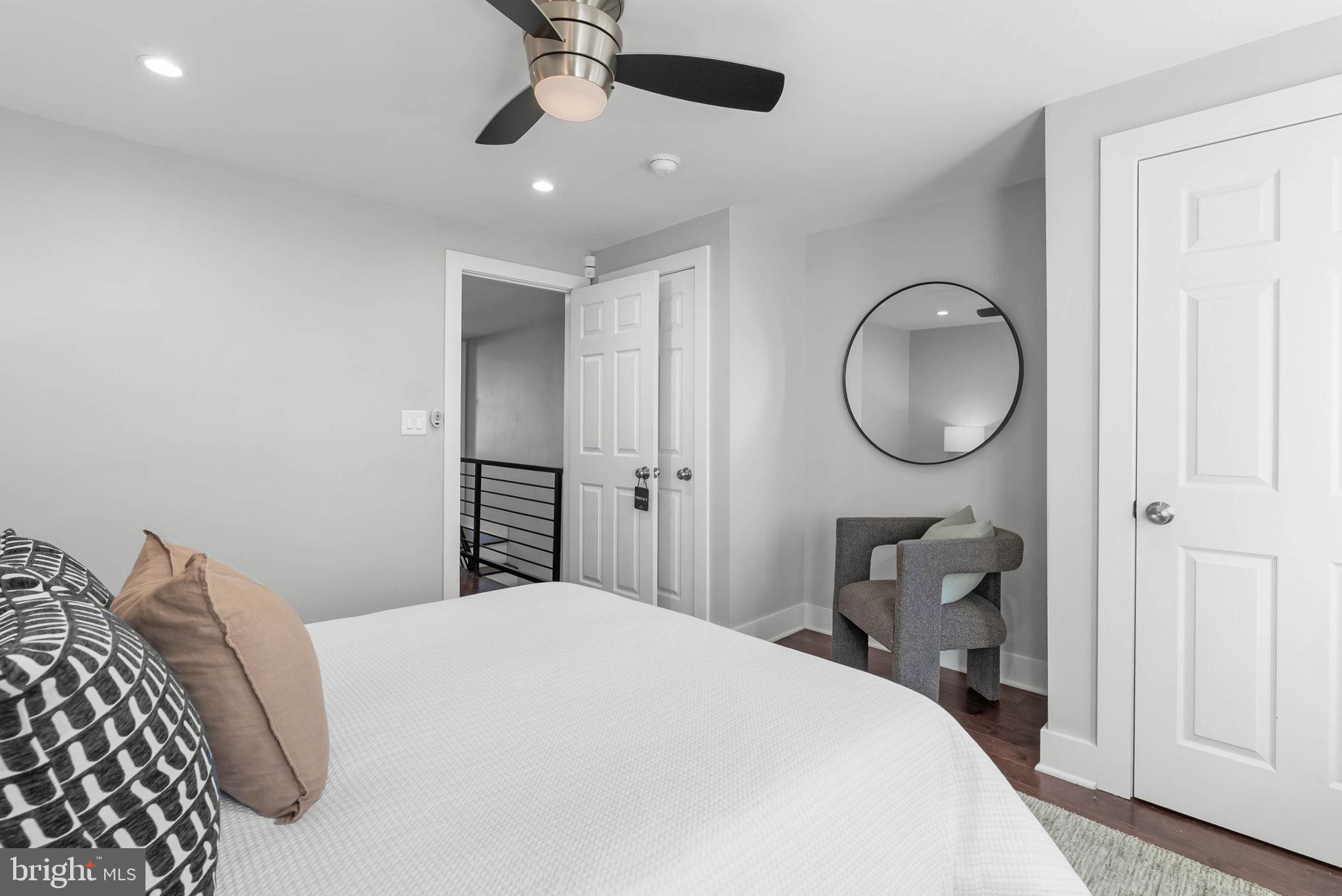 2639 Ellsworth Street Philadelphia, PA 19146 - Photo 10 of 20 a bedroom with a bed and a chandelier