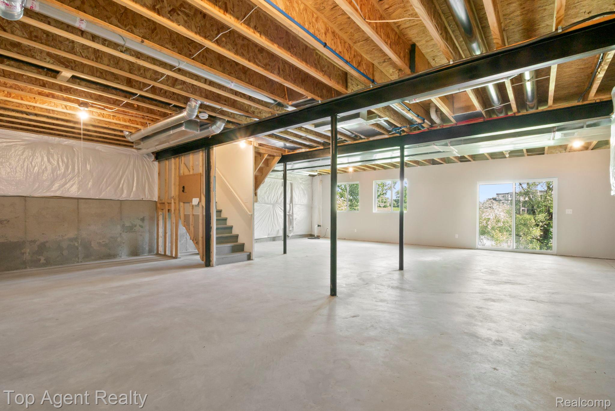 63770 Dequindre Road Washington, MI 48095 - Photo 49 of 61 Expansive unfinished lower level featuring exposed wood joists, concrete flooring, and an open layout