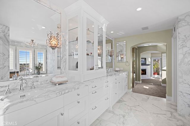 a spacious en suite bathroom with shower sink and mirror